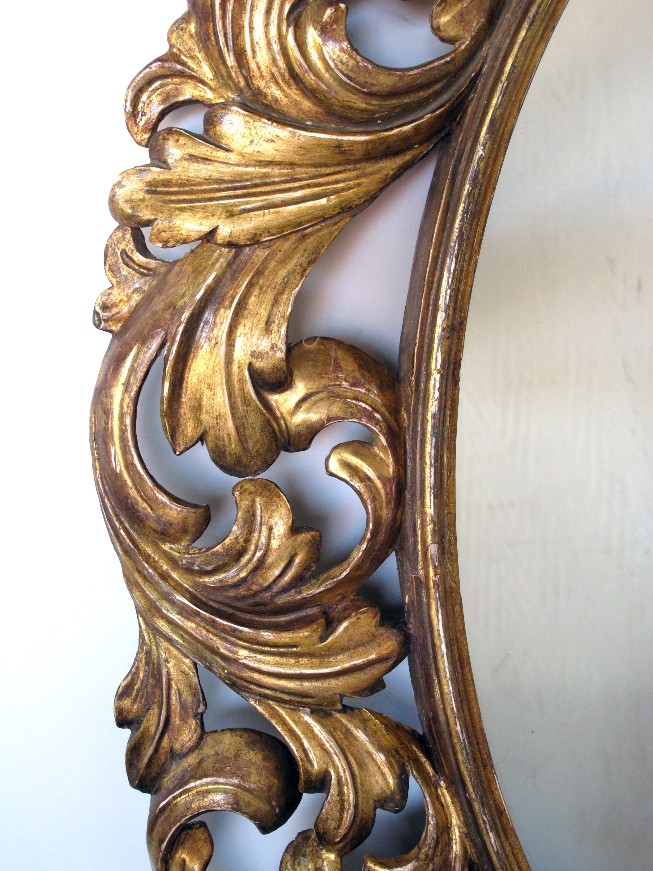 a well-carved italian baroque style oval gilt-wood mirror epoca