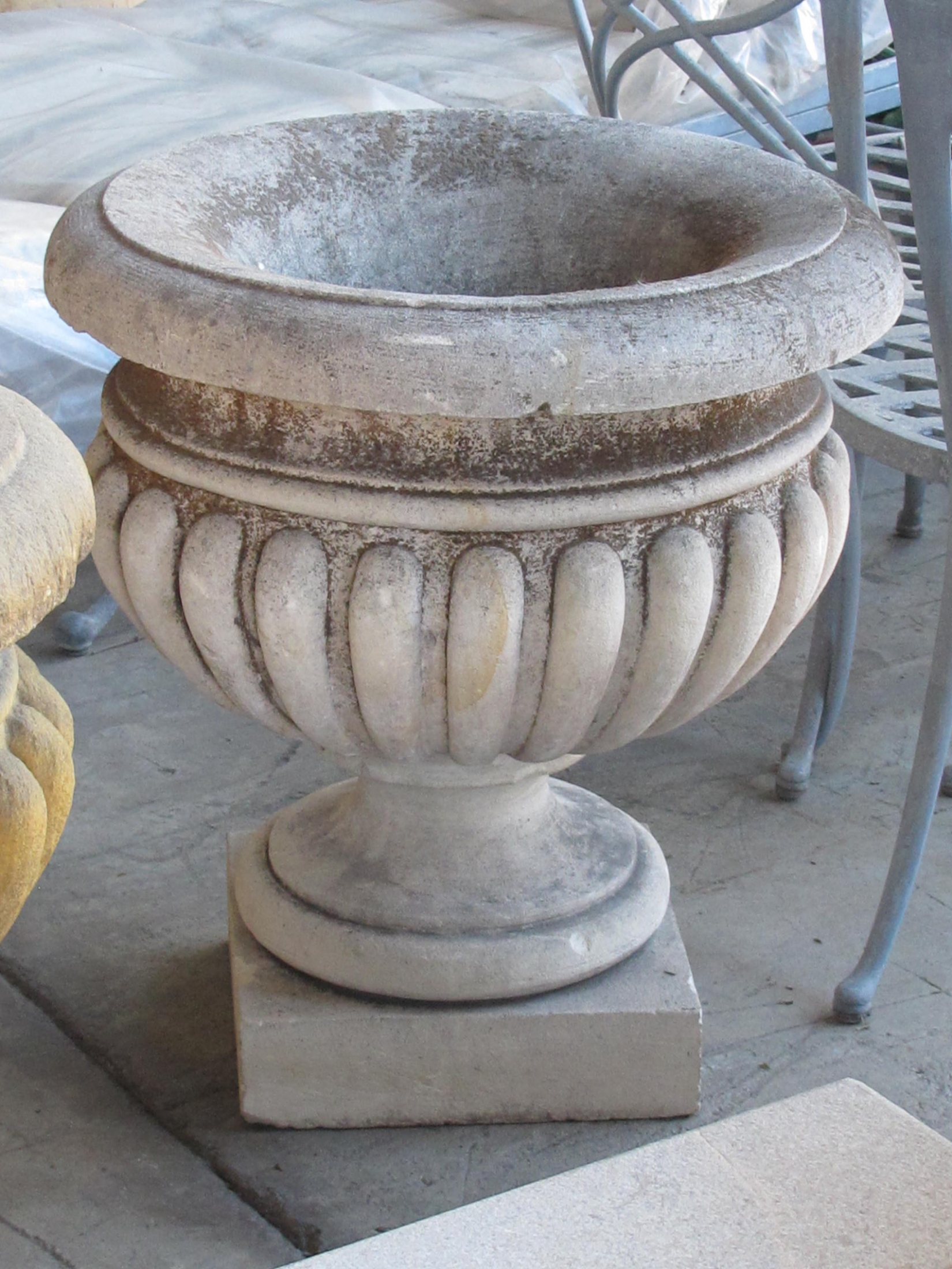 A Large-scaled French Neoclassical Carved Limestone Gadrooned Urns 