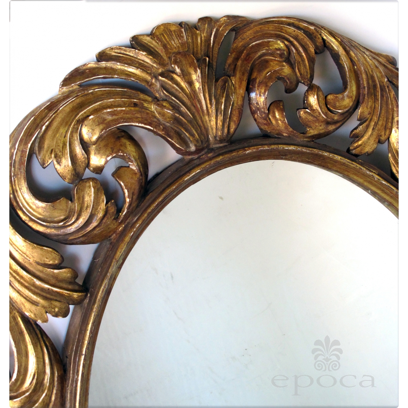 a well-carved italian baroque style oval gilt-wood mirror epoca